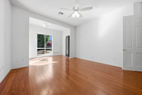 a view of a livingroom with wooden floor and a window