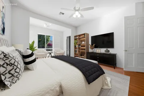 a bedroom with a large bed and a couch