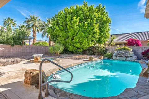 a view of a house with backyard sitting area and garden