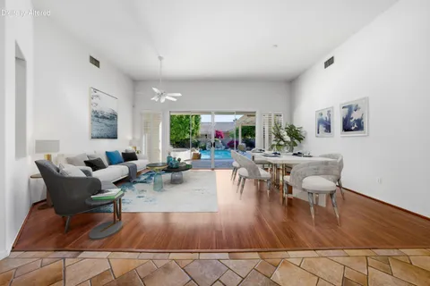 a view of a dining room with furniture large windows and wooden floor