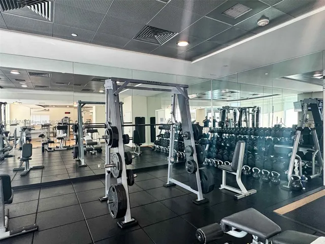 a gym room with lots of gym equipment