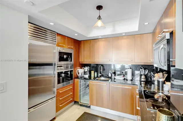 a kitchen with stainless steel appliances a refrigerator and a stove top oven