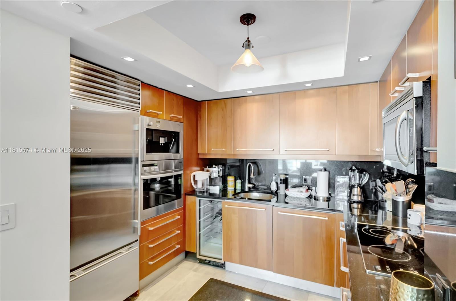 1331 Brickell Bay Drive, Unit 1504 Miami, FL 33131 - Photo 3 of 30 a kitchen with stainless steel appliances a refrigerator and a stove top oven
