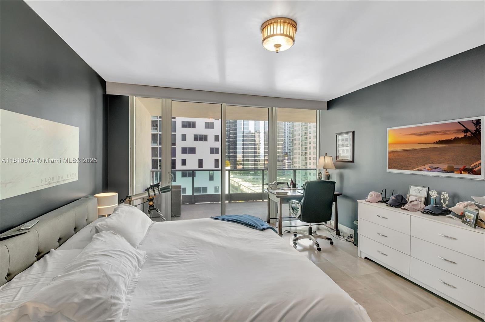 1331 Brickell Bay Drive, Unit 1504 Miami, FL 33131 - Photo 6 of 30 a bedroom with a bed and large windows