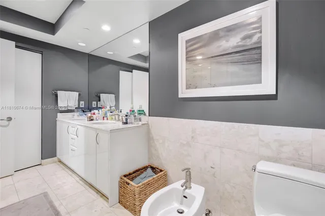 a bathroom with a sink mirror and toilet