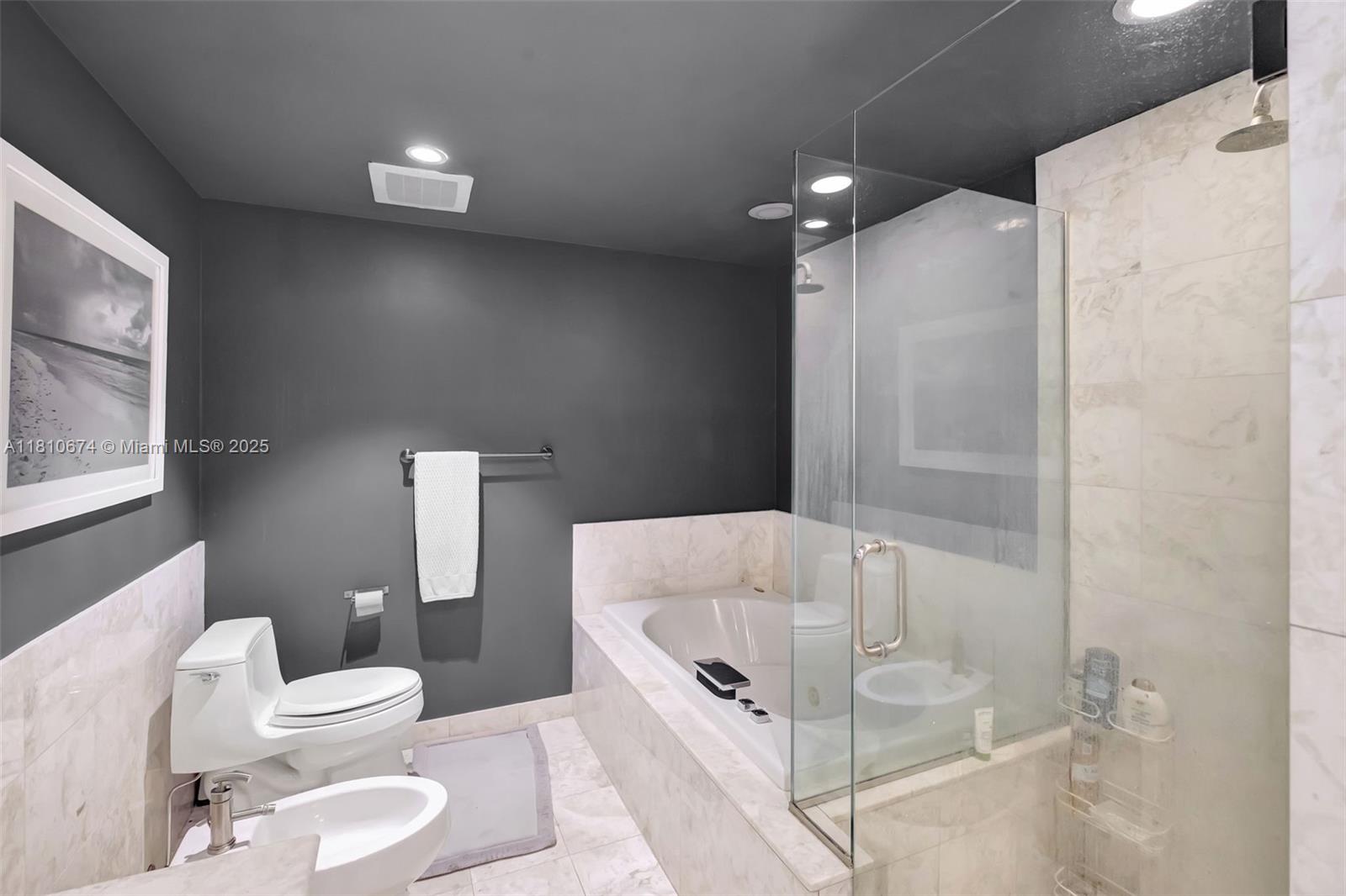 1331 Brickell Bay Drive, Unit 1504 Miami, FL 33131 - Photo 8 of 30 a bathroom with a tub toilet and shower