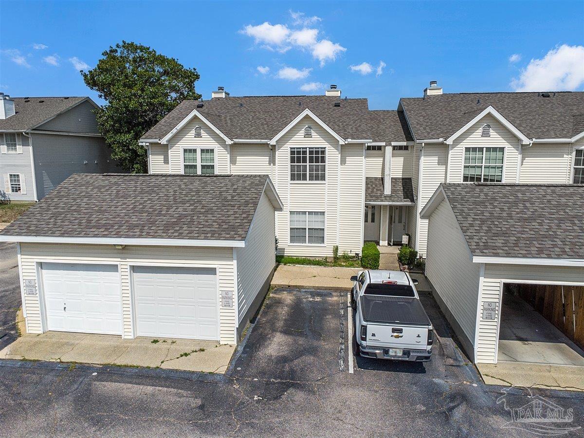 601 East Burgess Road, Unit J2 Pensacola, FL 32504 - Photo 1 of 38 a front view of a house with a yard