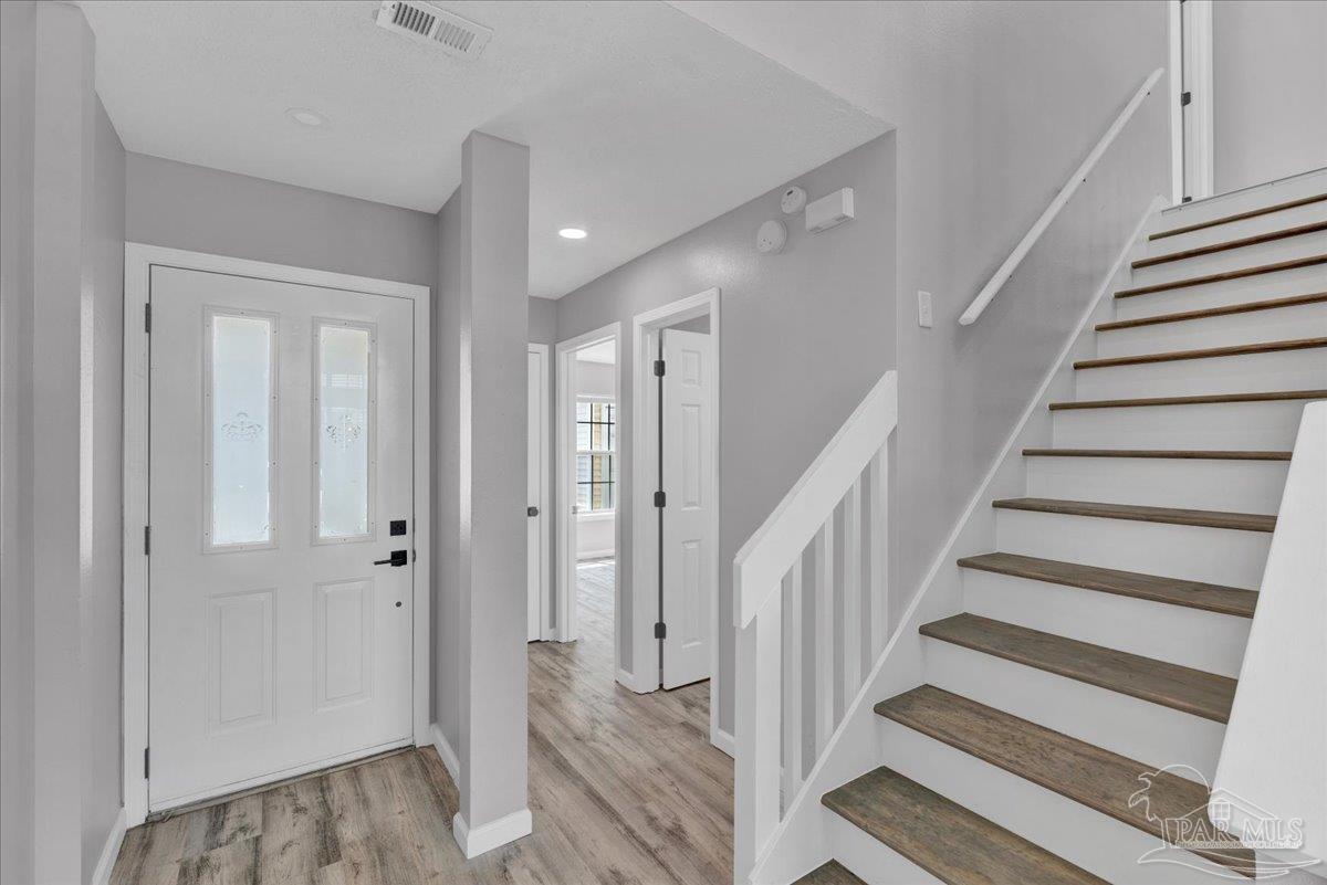 601 East Burgess Road, Unit J2 Pensacola, FL 32504 - Photo 14 of 38 a view of entryway with wooden floor and stairs