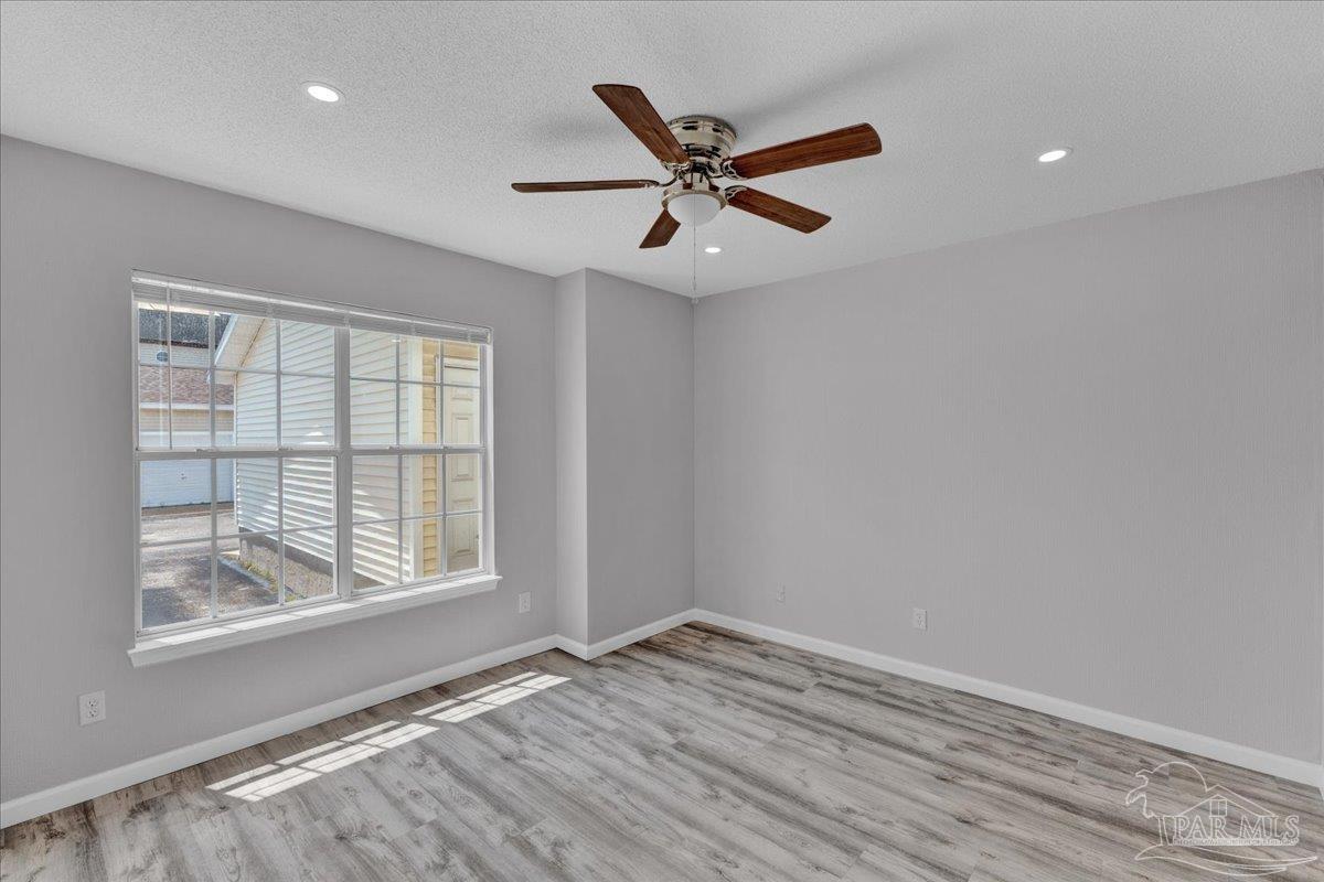 601 East Burgess Road, Unit J2 Pensacola, FL 32504 - Photo 15 of 38 a view of an empty room with wooden floor and a window