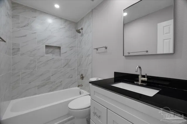 a bathroom with a sink a toilet and bathtub