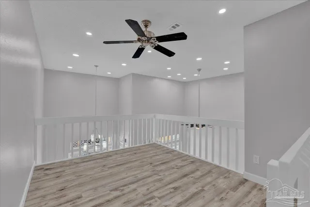 a view of an empty room and wooden floor