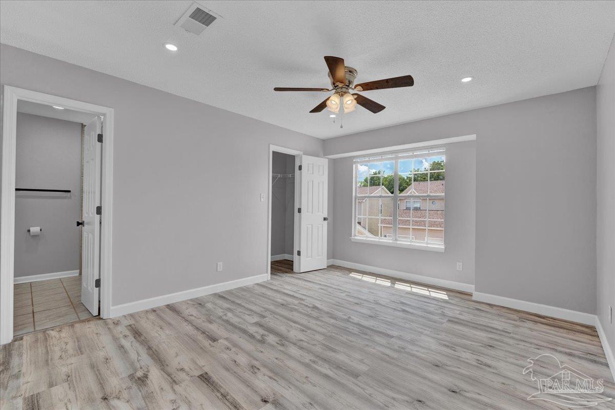 601 East Burgess Road, Unit J2 Pensacola, FL 32504 - Photo 21 of 38 a view of an empty room with wooden floor and a window
