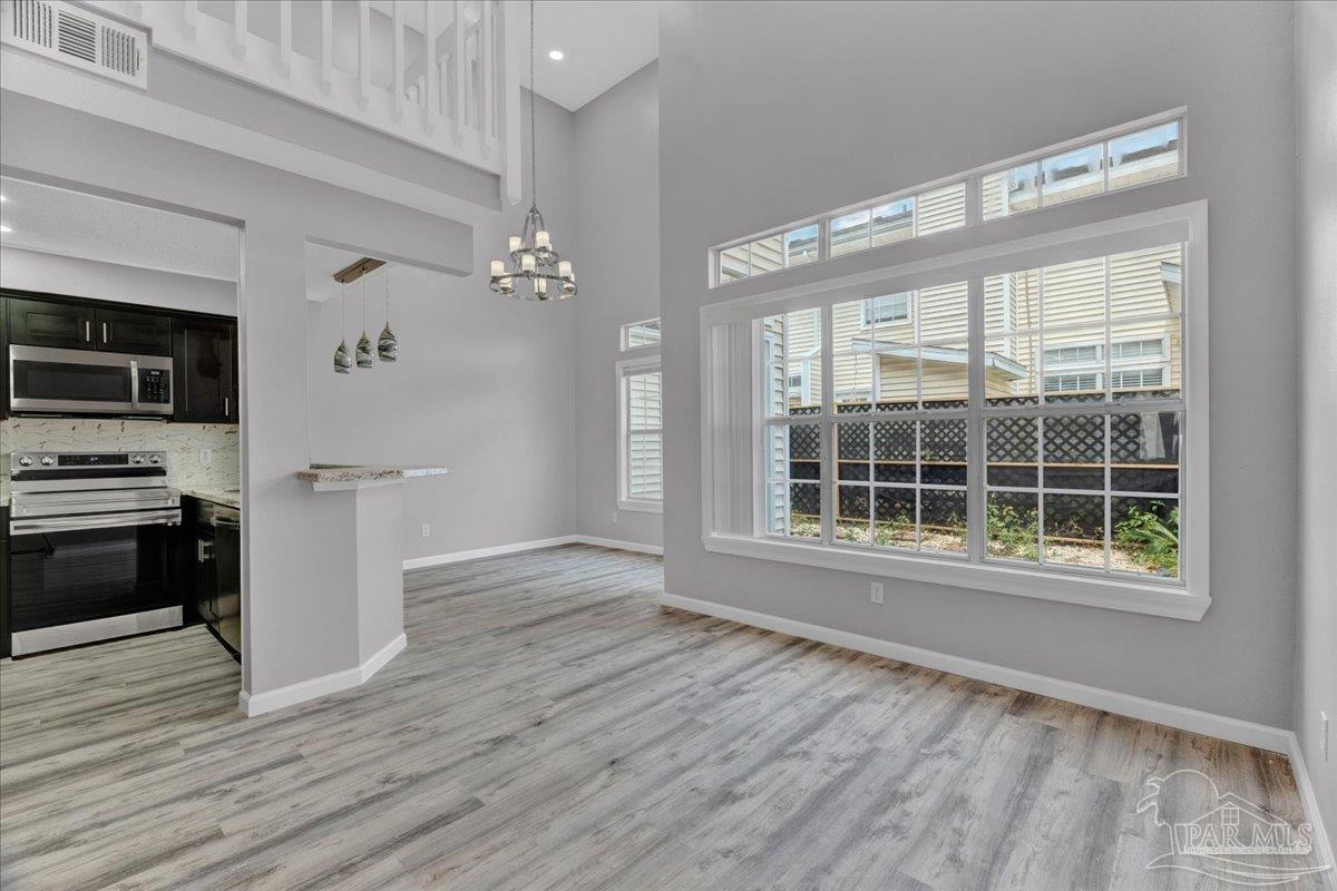 601 East Burgess Road, Unit J2 Pensacola, FL 32504 - Photo 28 of 38 a view of a kitchen with wooden floor and electronic appliances