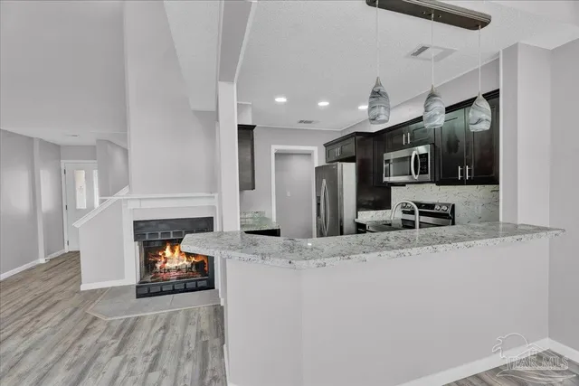 a kitchen with sink refrigerator and microwave