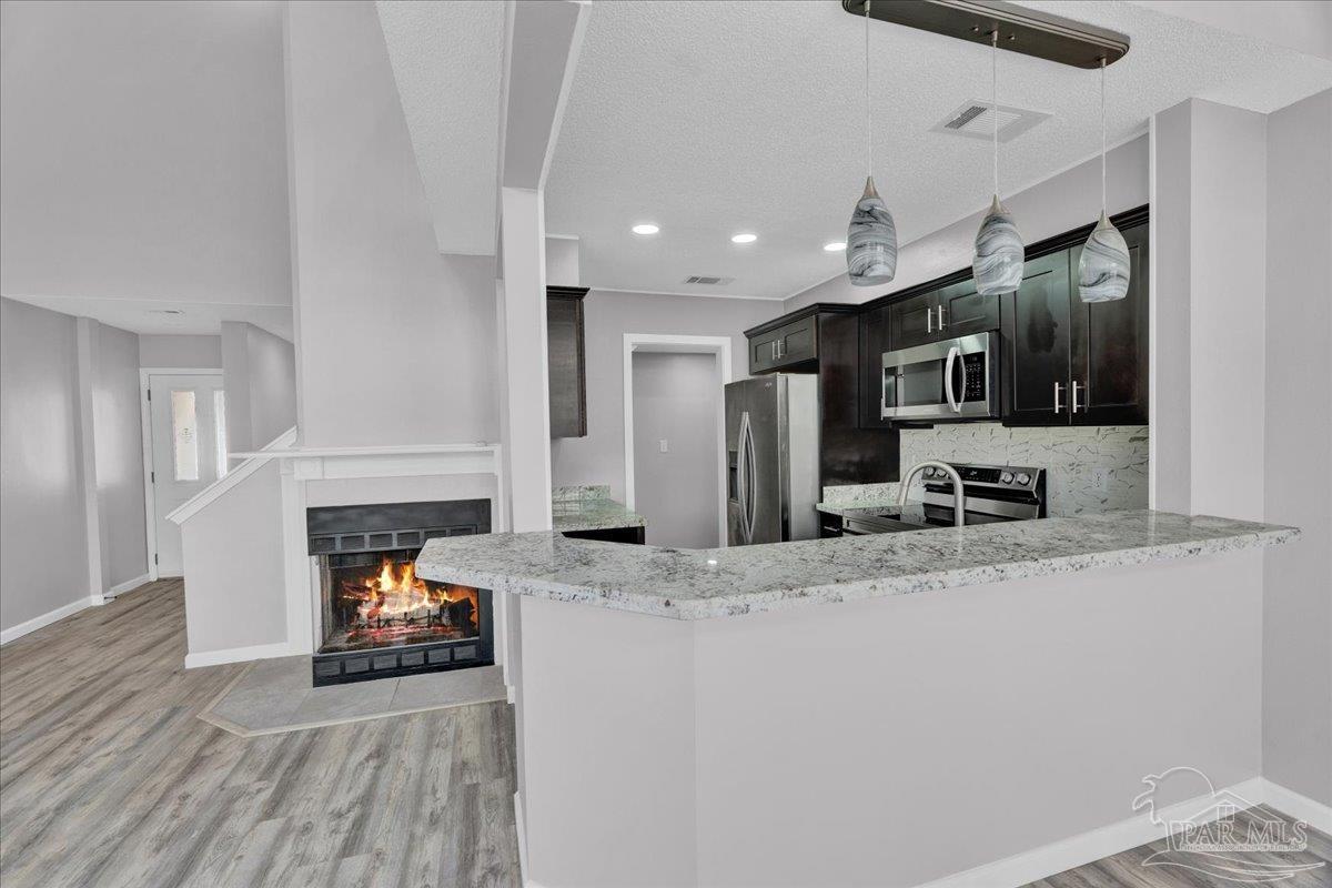 601 East Burgess Road, Unit J2 Pensacola, FL 32504 - Photo 29 of 38 a kitchen with sink refrigerator and microwave