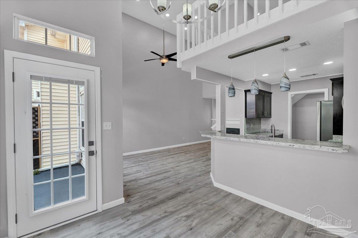 601 East Burgess Road, Unit J2 Pensacola, FL 32504 - Photo 30 of 38 a view of a kitchen with a sink and wooden floor