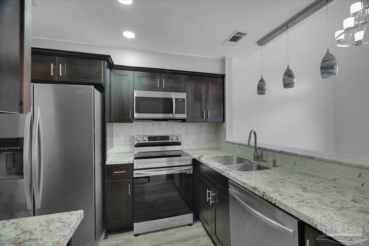 601 East Burgess Road, Unit J2 Pensacola, FL 32504 - Photo 31 of 38 a kitchen with a sink stainless steel appliances and a counter space