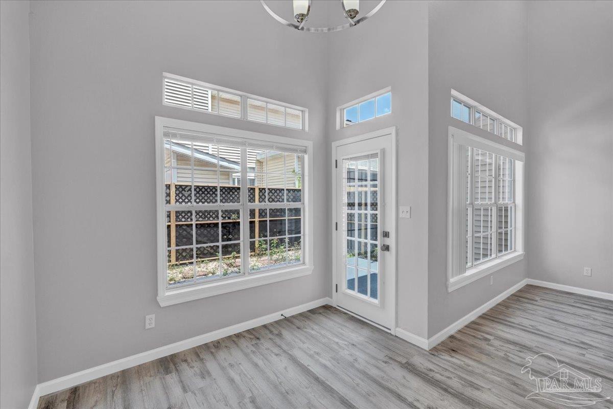 601 East Burgess Road, Unit J2 Pensacola, FL 32504 - Photo 34 of 38 a view of empty room with wooden floor and fan
