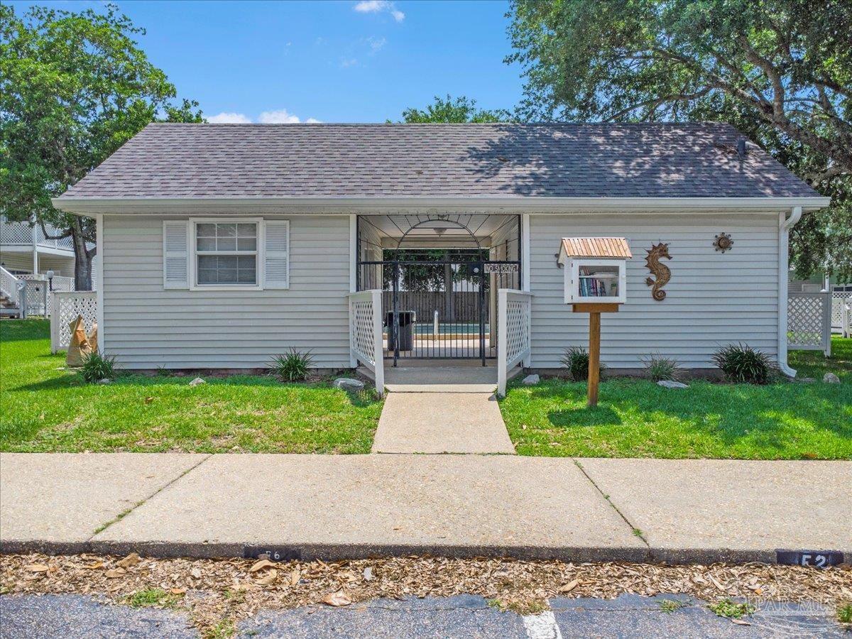 601 East Burgess Road, Unit J2 Pensacola, FL 32504 - Photo 6 of 38 a front view of a house with a garden