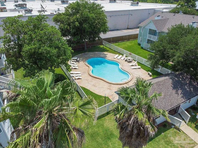 an aerial view of a house with swimming pool patio and outdoor seating