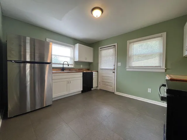 a kitchen with stainless steel appliances a refrigerator sink and cabinets