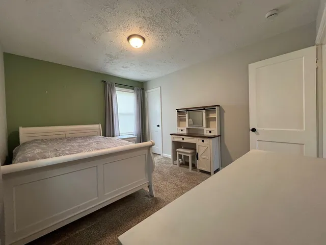 a living room with stainless steel appliances kitchen island furniture and a window