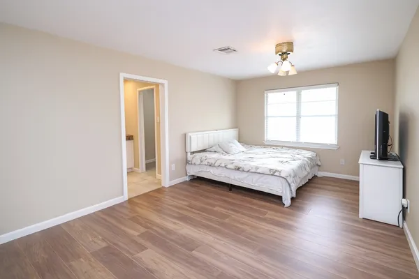 a bedroom with a bed and a chandelier
