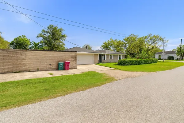 a view of house with outdoor space and garden