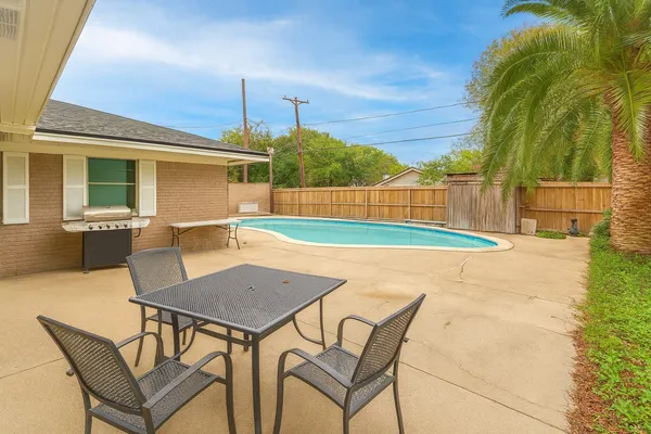a view of a swimming pool with a lounge chairs