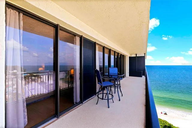 a view of a chairs and table in the balcony