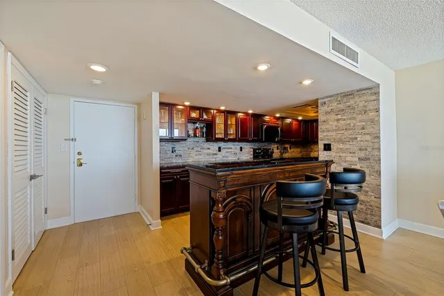 a kitchen with stainless steel appliances granite countertop a stove a sink and a refrigerator