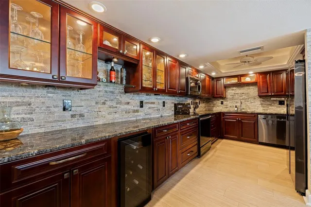 a kitchen with stainless steel appliances granite countertop a stove sink and cabinets