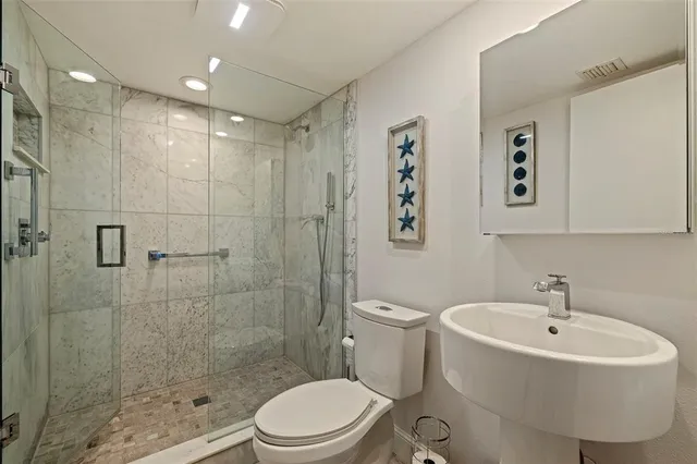 a bathroom with a sink toilet and shower
