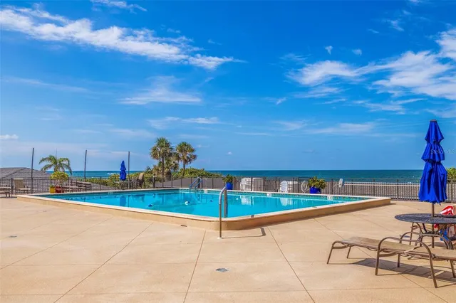a view of a swimming pool with an outdoor seating