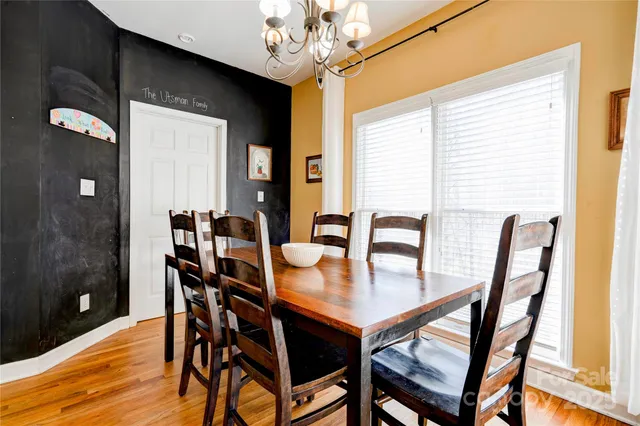 a view of a dining room with furniture and chandelier