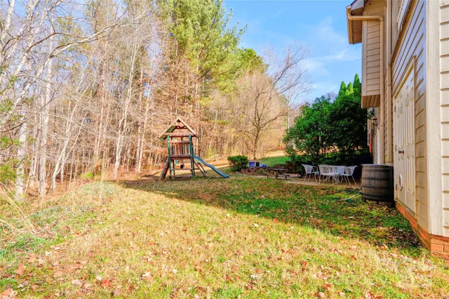 a view of a yard with yellow house
