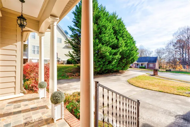 a view of a porch with a table and chairs next to a yard
