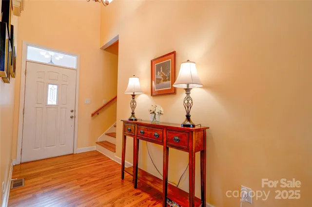 a view of entryway and hall with wooden floor