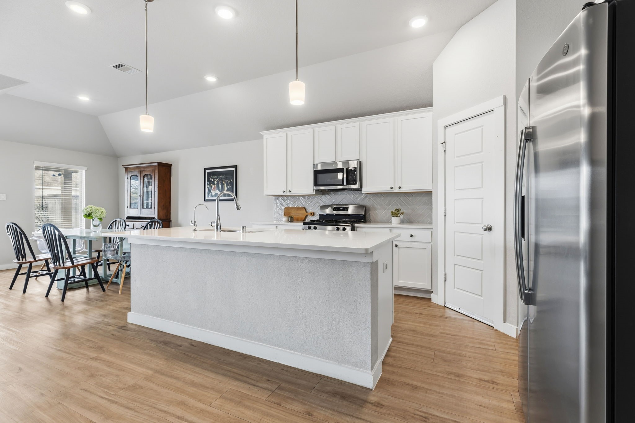 14914 Big Bend Ranch Drive Cypress, TX 77433 - Photo 2 of 49 a open kitchen with white cabinets and stainless steel appliances