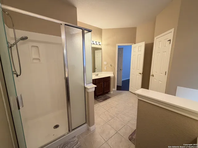 a view of hallway with shower and closet