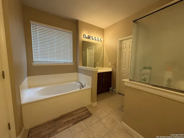 a bathroom with a bathtub and a shower