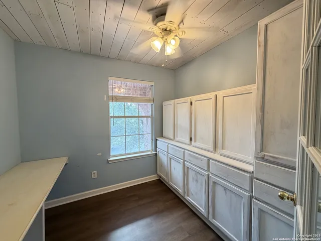 a view of an empty room with window and cabinet