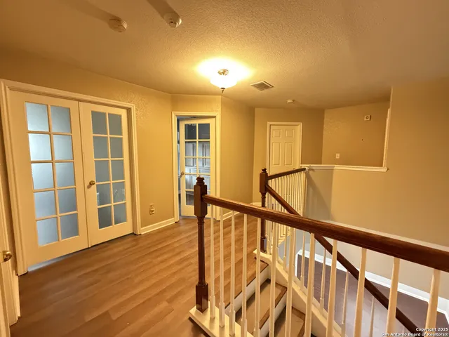 a view of an entryway with wooden floor and windows