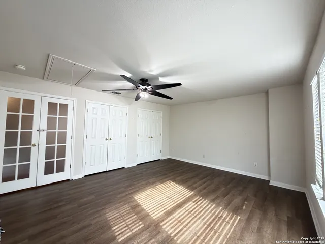 a view of empty room with wooden floor