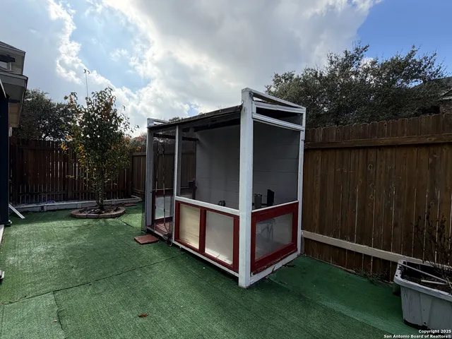 a view of backyard with tub and trees