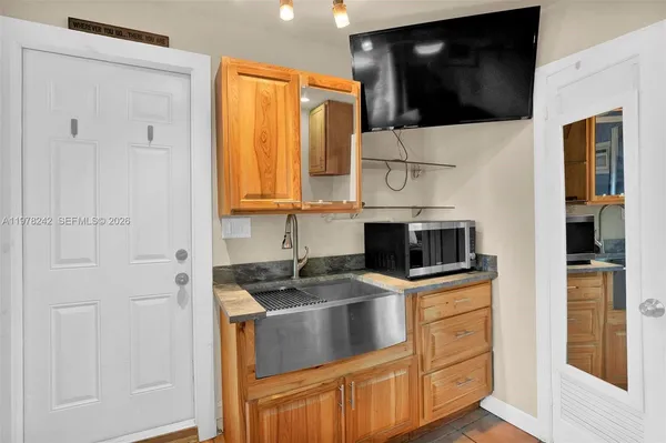 a kitchen with stainless steel appliances a stove a microwave a sink and cabinets