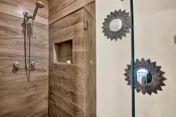a bathroom with a shower and mirror
