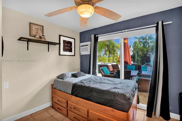 a bedroom with a bed and a large window