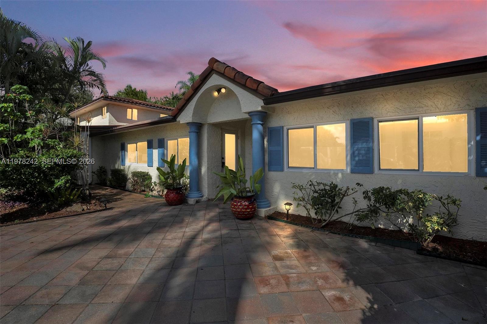 812 Chukker Road, Unit 4 Delray Beach, FL 33483 - Photo 9 of 10 a front view of a house with a yard