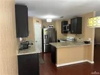 a bathroom with a granite countertop sink a mirror and shower